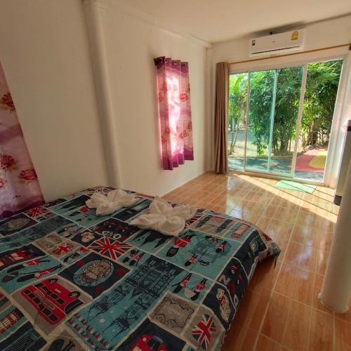 a bedroom with a bed with a quilt on it at Rasta view Bangalows in Ko Chang