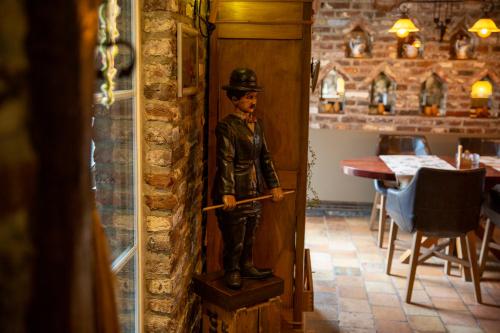 a statue of a man standing on a box in a room at Hotel De Oude Brouwerij in Mechelen