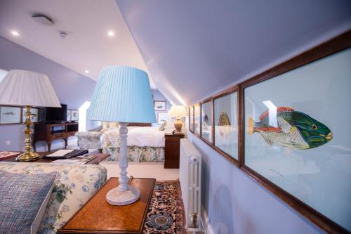 a room with a bed and a lamp on a table at The Granary Lodge Bed & Breakfast in Thurso