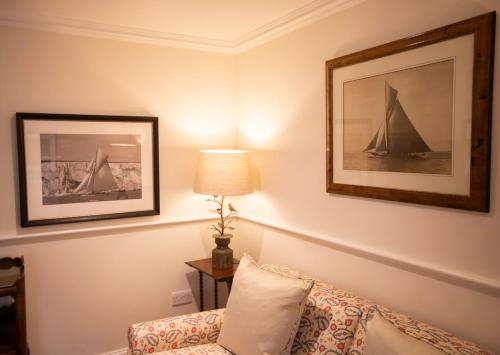 a room with a couch and a picture of a sailboat at The Granary Lodge Bed & Breakfast in Thurso