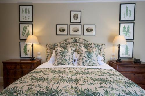 a bedroom with a bed and three pictures on the wall at The Granary Lodge Bed & Breakfast in Thurso