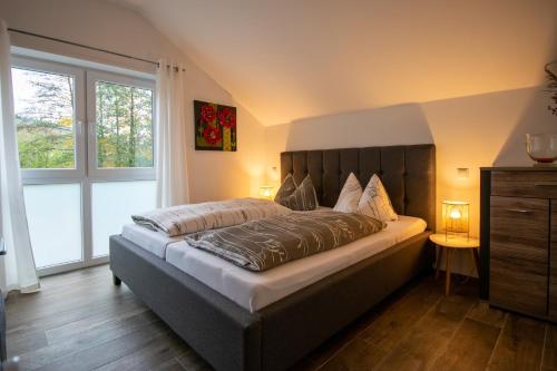 sypialnia z dużym łóżkiem i dużym oknem w obiekcie Alte Mühle Hotel & Restaurant w mieście Rödental