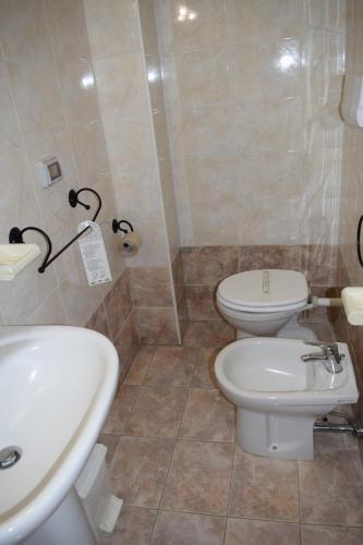 a bathroom with a white sink and a toilet at Hostel il Tetto in Melfi