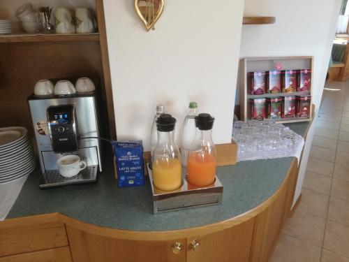 two bottles of orange juice sitting on a kitchen counter at Garnì Piz da L'Ander in Corvara in Badia