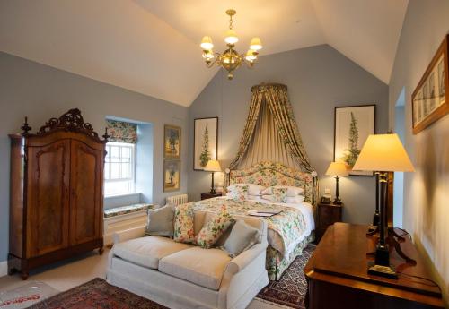 a bedroom with a bed and a couch at The Granary Lodge Bed & Breakfast in Thurso