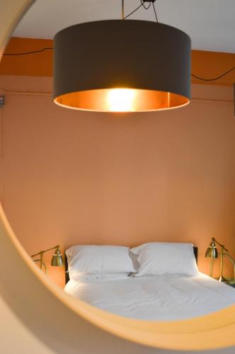a bedroom with a bed with a large light above it at The Bristol Wing in Bristol