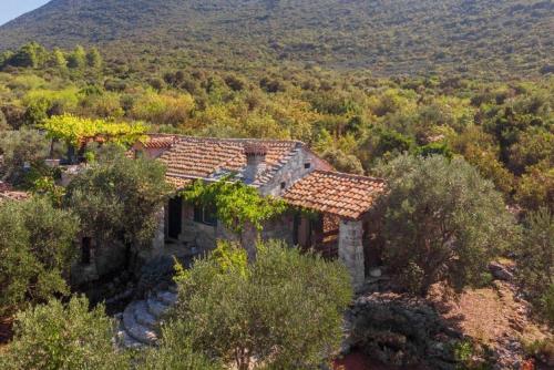 a stone house in the middle of a forest at Lavender Cottage in Trpanj