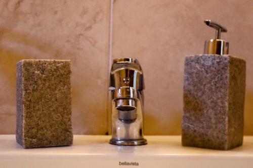 a bathroom sink with a faucet and two towels at Akti Rooms And Studios in Livadion