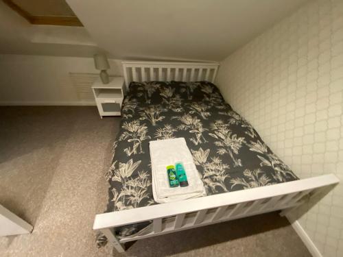 a small bed in a small room with two batteries on it at The Attic En-suite Room in Plymouth