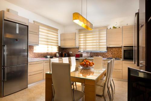 a kitchen with a table with a bowl of fruit on it at Antigone Estate in Koskinou