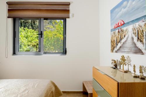 a bedroom with a bed and a window at Antigone Estate in Koskinou