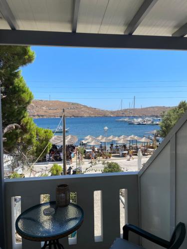 a balcony with a table and a view of a beach at Akti Rooms And Studios in Livadion