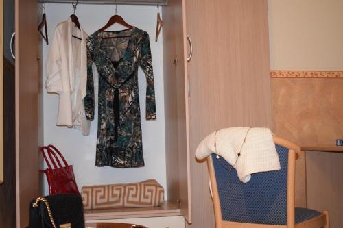 a dressing room with a dress and a chair at Hostel il Tetto in Melfi