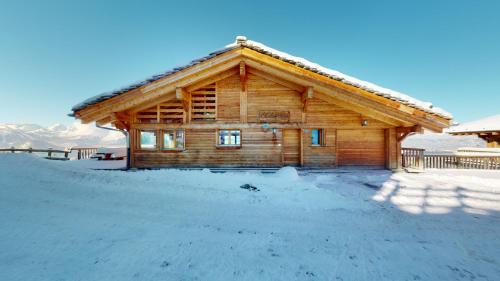 a log cabin with snow in front of it at Egg SAUNA & LUXURY chalet 16 pers by Alpvision Résidences in Veysonnaz