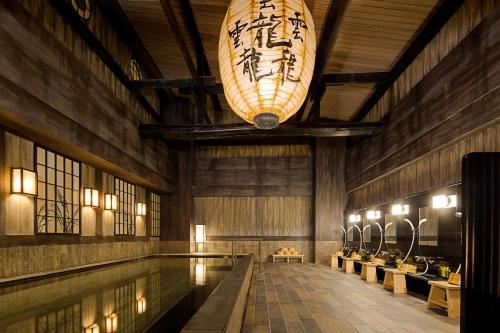 a swimming pool in a building with a chandelier at La'gent Stay Sapporo Odori Hokkaido in Sapporo