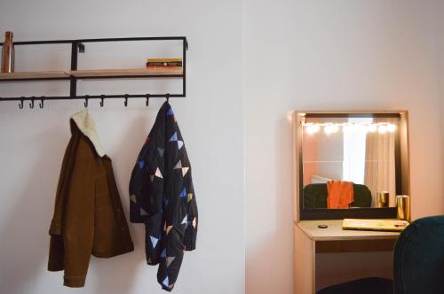 a room with a mirror and coats hanging on a wall at The Bristol Wing in Bristol