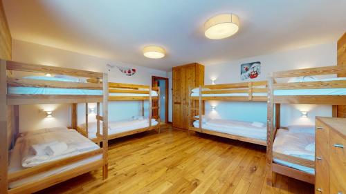 a room with four bunk beds in it at Egg SAUNA & LUXURY chalet 16 pers by Alpvision Résidences in Veysonnaz