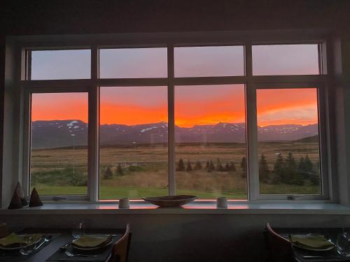 a window with a view of a sunset seen through it at Soti Lodge in Fljot
