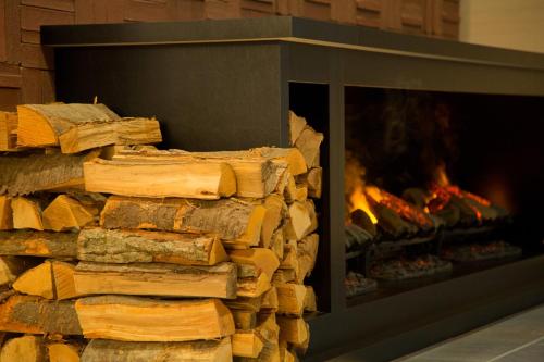 a stack of logs in front of a fireplace at La'gent Stay Sapporo Odori Hokkaido in Sapporo