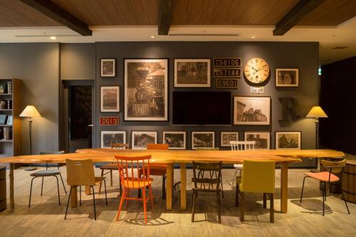 a dining room with a large wooden table and chairs at La'gent Stay Sapporo Odori Hokkaido in Sapporo