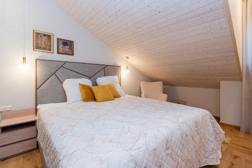 a bedroom with a large bed in a attic at Memel Townhouse apartamentai in Klaipėda