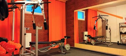 a gym with two exercise bikes and a mirror at Resort Dlouhé Stráně in Loučná nad Desnou