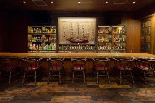 a bar in a restaurant with chairs around it at La'gent Stay Sapporo Odori Hokkaido in Sapporo
