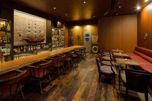 a bar with tables and chairs in a restaurant at La'gent Stay Sapporo Odori Hokkaido in Sapporo