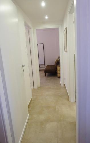 an empty hallway with a couch in a room at Sperlonga By The Sea in Sperlonga