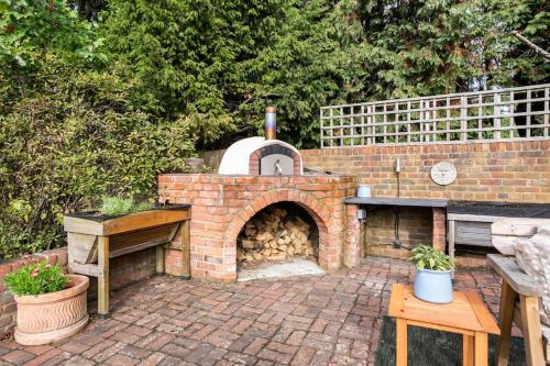 an outdoor brick oven with a table and benches at Idyllic 2- Bedroom barn with amazing views in Cranbrook