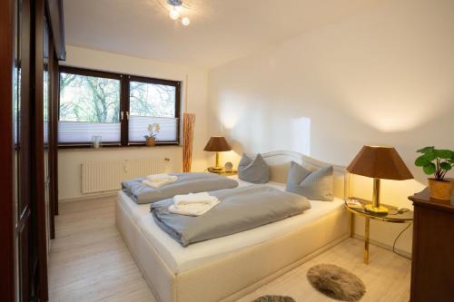 a bedroom with a bed and two lamps and a window at Bismarckstraße 27 in Bad Sachsa