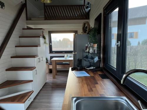 a kitchen with a sink and a staircase in a tiny house at TinyHouse -Reset im Vilstal -Zurück zum Ursprung in Aldersbach
