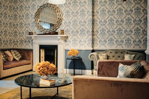 a living room with a couch and a table at Hotel De Normandie in Saint Helier Jersey