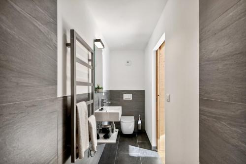a bathroom with a sink and a toilet at Chalet Les Rahâs by Mrs Miggins in Grimentz