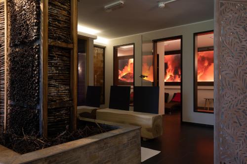 a room with a fireplace with fire in the windows at Hotel Lindenhof in Wittlich