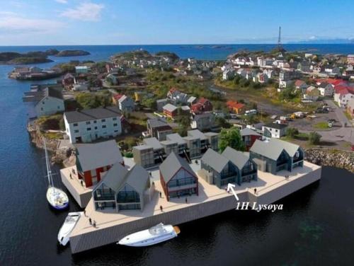 an artists rendering of an island with houses and a dock at Rorbuleilighet Lysøya 1H in Henningsvær