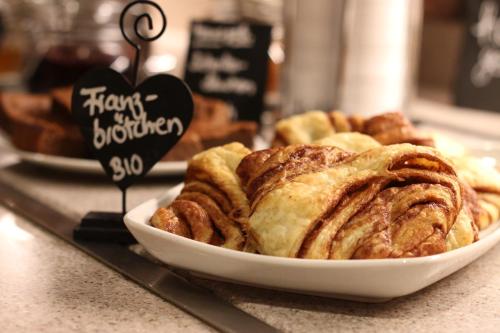 a plate of pastries on a counter in a bakery at Hotel Sonnenhügel in Bad Bevensen