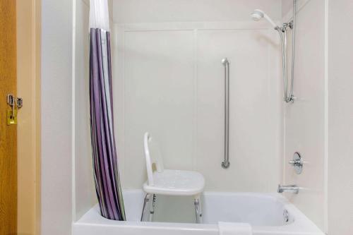 a white bathroom with a toilet and a shower at La Quinta by Wyndham Springfield South in Springfield