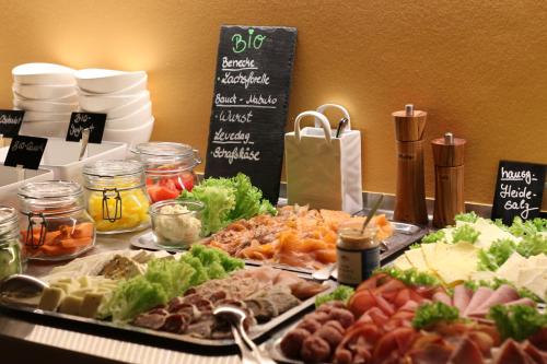 a buffet of different types of food on a table at Hotel Sonnenhügel in Bad Bevensen