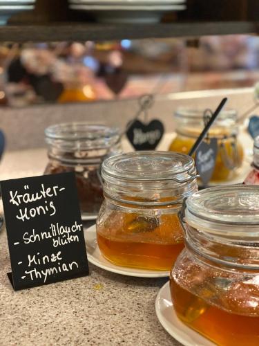 a bunch of jars of honey on a counter at Hotel Sonnenhügel in Bad Bevensen