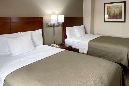 a hotel room with two beds and a phone at Econo Lodge Cartersville-Emerson Lake Point in Cartersville