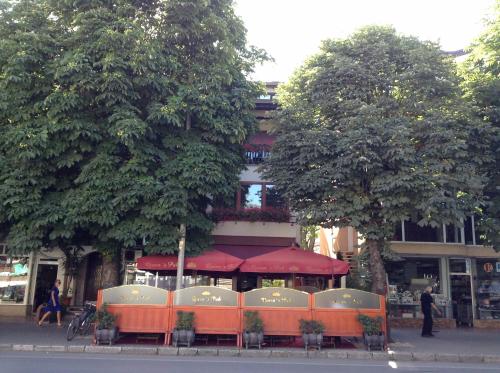 a group of orange tables and chairs in front of a building at Ivanoski Studios and Guest Rooms in Ohrid