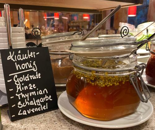 a jar of honey on a counter with a sign at Hotel Sonnenhügel in Bad Bevensen