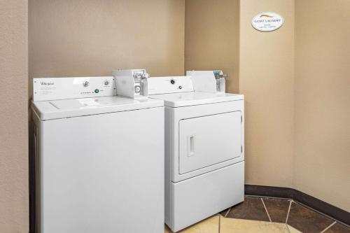 a white washer and dryer in a room at Baymont by Wyndham Milan in Milan