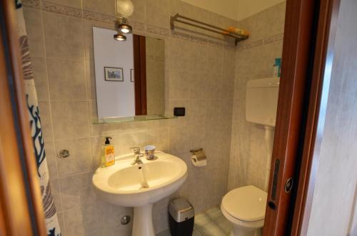 a bathroom with a sink and a toilet at Lake View Apartment Golden Triangle in Acquaseria