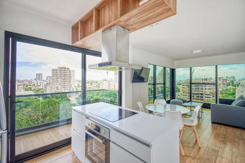 a kitchen and dining room with a view of the city at Live Soho Boutique & Apartments Belgrano in Buenos Aires