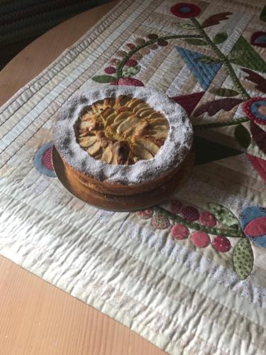 a pie in a bowl sitting on a table at Appartamento A Due Passi in Farra dʼAlpago