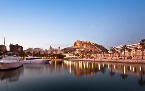 a view of a city with boats in the water at Atico Dos Alturas Alicante in Alicante