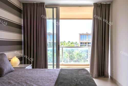 a bedroom with a bed and a large window at Apartamento Chocolate - 300 meters from Salgados beach in Guia