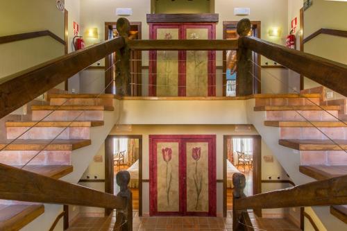 a spiral staircase in a house with colorful doors at El Rincón de Rascafría in Rascafría